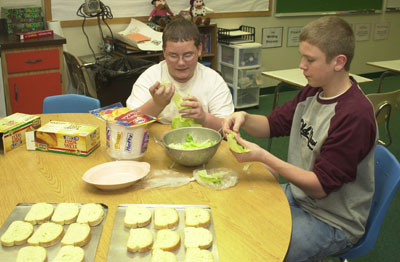 Josh Stucky browns hamburger to go into spaghetti sauce as part of the Cooking Club. The members cooked a full meal of spaghetti with meat sauce, a salad and garlic bread.<br>dailystandard.com