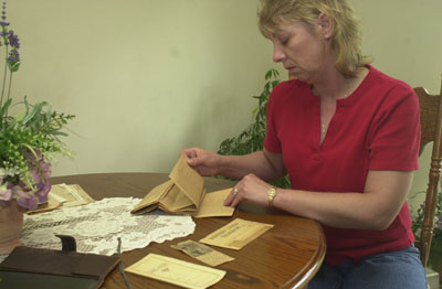 Fort Recovery resident Dixie Timmerman looks through yellowed documents that shed some light on the military history her father, Walter 