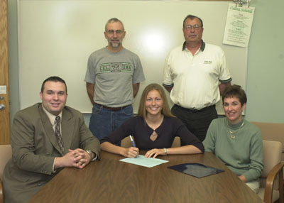 Celina senior Kara Osterfeld, seated center, will make the trip to Columbia, Kentucky, to play basketball for Lindsey Wilson College. Seated with Kara are LWC assistant coach Eddie Ingle and mother Sue Osterfeld. In the back are father Bob Osterfeld and longtime Celina head basketball coach Jack Clouse.<br>dailystandard.com