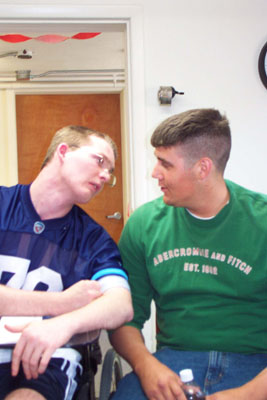 Still overcome by emotion, Dusty Aller leans toward his friend and hero, Justin Cotterman, during a surprise reunion held Wednesday at the Mercer County Educational Service Center. Aller, who sustained brain injuries in an April 2001 traffic accident, composed and sent letters to Cotterman while he served with the U.S. Army Reserves in Iraq.<br>dailystandard.com