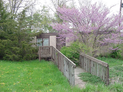 A mobile home in the rear of Resthaven Memory Gardens, on County 33A near Howell Road, east of St. Marys, is overgrown with bushes and trees after years of neglect at the cemetery. Washington Township officials assumed control of the cemetery this week and will remove the trailer.<br>dailystandard.com