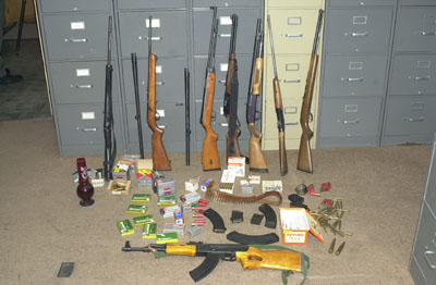 Mercer County Sheriff's deputies found this collection of weapons and ammunition while searching the Timothy Sturgis home at 1507 Pine Road, Celina, on Wednesday. Two 50-caliber rounds lay next to a 44-caliber Magnum round and a quarter. A methamphetamine lab was found in an outbuilding at the Sturgis property. The lab showed signs of having been used after the Celina man was sentenced to three years in prison April 29 for possessing the illicit drug. Two men have been indicted on drug charges while deputies were in the process of serving arrest warrants for three more individuals this morning.<br>dailystandard.com