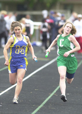 St. Marys' Michaella Fenwick, left, and Celina's Meg Smalley, right, run their relay leg during the WBL meet on Saturday.<br>dailystandard.com