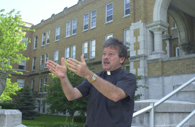 St. Charles Center Director, the Rev. James Seibert, explains the renovation project for the 105,900-square-foot four-story main building. The center will be a flurry of activity next week when contractors begin converting a portion of the building into 55 one- and two-bedroom apartments.<br>dailystandard.com