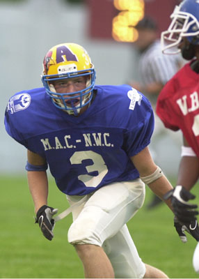 Marion Local's Andy Schulze, 3, keeps an eye on Defiance wide receiver L.J. Helton, right, during the Van Wert County Hospital All-Star football game made up of players from three conferences on Friday. The MAC/NWC team defeated the WBL squad, 27-19.<br>dailystandard.com