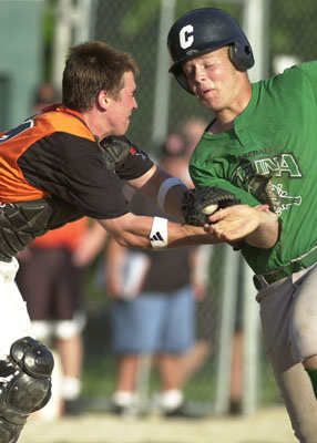 Celina's Doug Vorhees, right, is tagged out at home plate by Coldwater catcher Dave Wenning during their ACME matchup on Monday night at Eastview Park. Celina went on to defeat Coldwater 6-1 behind a strong pitching performance by Eric Braun.<br>dailystandard.com