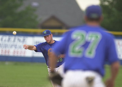 Grand Lake second baseman Mike Bertrum, left, throws the ball to first baseman Andy Hudak, 27, for an out during the Mariners' 6-0 win over Decatur on Tuesday night at Jim Hoess Field.<br>dailystandard.com