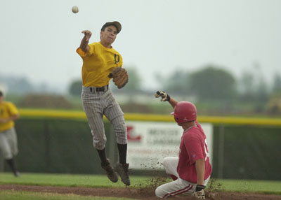 Parkway's Rikki Covarrubius, left, fires to first base after forcing our St. Henry's Brady Schmitz at second during Thursday's game at Don Black Field in Rockford.<br>dailystandard.com