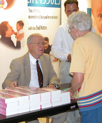 Maria Stein native Dr. John Willke answers questions during a book-signing event following a presentation by the pro-life speaker and author at the Spiritual Center in Maria Stein on Sunday.<br>dailystandard.com