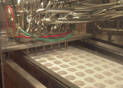 Computerized equipment at The Dannon Company in Minster measures consistency and quality of each batch. An automatic filler delivers a metered flow of yogurt as cups move through the packaging area. <br>dailystandard.com
