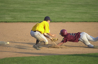 St. Henry Legion Post 648 baserunner Lenny Koesters, right, slides around the tag from St. Marys Legion Post 323 second baseman Matt Helmstetter, left, during their contest on Tuesday night. St. Henry Legion Post 648 won the game 4-1 to improve to 8-3 on the season.<br>dailystandard.com
