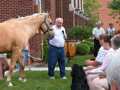 Pastor Bob Metheny talks to his congregation Wednesday night about the longtime companionship he's had with his horse, Copper, during a Blessing of the Animals service. <br>dailystandard.com
