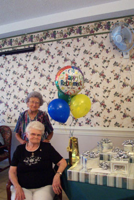 Retirees Anna Marie Dircksen of Minster, seated, and Rosemary Moeller of Maria Stein share comments with residents and staff members during their retirement party at Heritage Manor Nursing Center in Minster. <br>dailystandard.com