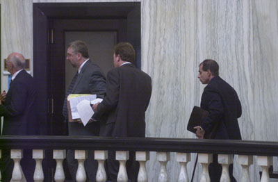 Dr. Thomas Santanello follows his lawyers, Ralph Buss, David Koerner and Mark Kaiser, into a conference room on the third floor of the Mercer County Courthouse on Thursday afternoon.<br>dailystandard.com