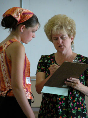 Stephanie Fisher of the Moulton Lucky Livestock <br>4-H Club listens intently as judge Joyce Larimore interviews her in the Junior Fair clothing/-middle school <br>category at the Auglaize County Fairgrounds on Thursday.<br>  <br>dailystandard.com