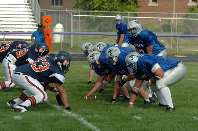 The Mercer County Cougar offensive line, right, gets set as quarterback Adam Wenning calls the play during the team's home opener against the Kosciusko County Mustangs at Barrenbrugge Park in Fort Recovery.<br>dailystandard.com