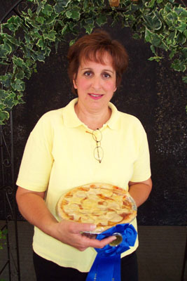Diane Menchhofer of Celina holds her prize-winning entry in Saturday's peach pie contest at the Mercer County Banner Fair. This marks the fourth year area residents Glen and June Florence have sponsored the event and put up the prize money.<br>dailystandard.com