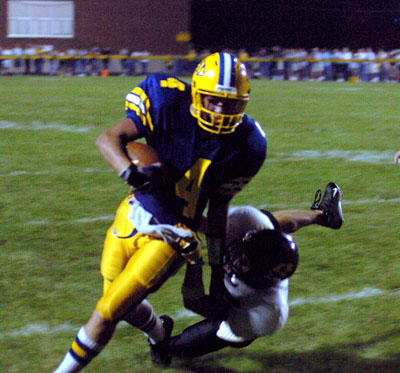 St. Marys' Tom Burke turns this pass reception into a 15-yard gain during Friday's game against Sidney. St. Marys defeated Sidney, 42-0.<br>dailystandard.com