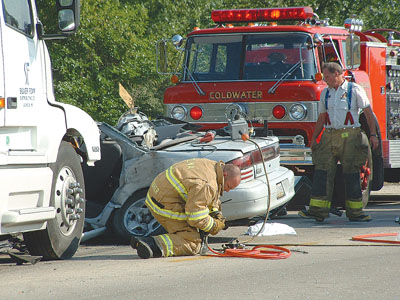 Rescuers remove equipment used to free two Coldwater girls from the wreckage of a car struck by a semitrailer shortly before 4:30 p.m. on Thursday at the intersection of U.S. 127 and Coldwater-Creek Road, south of Celina. Erin Pfaff, the 18-year-old driver, and Olivia Meyers, her 16-year-old passenger, remain in critical condition.<br>dailystandard.com