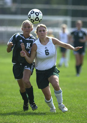 Celina's Lindsay Miller, 6, tries to beat Greenville defender Emily Melling during Saturday's match.<br>dailystandard.com