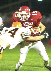Coldwater's Kyle Uhlenhake, 54, puts a big hit on St. Henry's Ryan Hartke, 15, during their game on Friday night. Coldwater's defense was the difference in a 28-0 win over St. Henry.<br>dailystandard.com