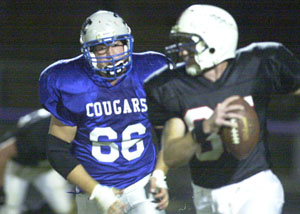 Mercer County lineman Al Rinderle, 66, gives chase to South Central quarterback Mike Catherson during Saturday's IFL Playoff game at Barrenbrugge Park in Fort Recovery.<br>dailystandard.com