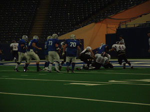 Mercer County quarterback Adam Wenning, 7, is stopped short of the goal line by several Darke County defenders on a conversion try during Sunday's IFL Title Game at the RCA Dome in Indianapolis. The Cougars lost to the Warriors 28-20.<br>dailystandard.com