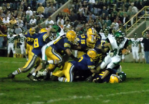 Celina's Kelly Mallory, 46, is met in the hole by a host of St. Marys defensive players during the Annual Battle of Grand Lake on Friday. St. Marys defeated Celina for the sixth straight time, 35-14.<br>dailystandard.com