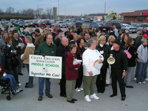 About 200 members of the Celina Education Association and Ohio Association of Public School Employees Local 457 rallied in the old Big Bear parking lot for a march of several blocks to the Celina board of education meeting Monday evening. Both organizations have been working without a contract for several months and are currently in negotiation with the board, facilitated by a federal mediator. Their number increased to almost 300 at the meeting site. In foreground, CEA Vice President Kathy Hart, Local 457 President Carol Henderson and CEA President Phil Long give encouragement to the membership.<br>dailystandard.com
