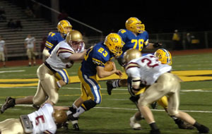 St. Marys' Justin Nagel, 23, tries to weave his way through a group of Watterson defenders. Nagel's 62-yard touchdown run in the second half put St. Marys up for good en route to a 14-3 win.<br>dailystandard.com