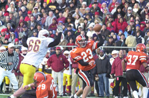 Versailles' Tony McNeilan, 23, fires a pass downfield as a Youngstown Mooney defender closes in. Since the Tigers got behind early, McNeilan was forced to throw the ball more than usual as Mooney defeated Versailles, 28-6.<br>dailystandard.com