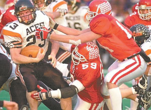 St. Henry's Kalen Hemmelgarn, 59, and teammate Toby Boeckman, right, combine to make a tackle on an Amanda-Clearcreek ballcarrier during Saturday's Division V state championship game. St. Henry's defense was strong all game long and led the way for the Redskins' 35-7 win. It's the fifth state title in school history for St. Henry football.<br>dailystandard.com