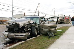 A heavily damaged Buick Park Avenue rests along East Spring Street in St. Marys after it collided with a semitrailer near Knoxville Avenue on Thursday afternoon. The driver, John Knapke, 78, of New Bremen, was pronounced dead shortly after the accident. His wife, Mary Ann Knapke, was listed in serious condition this morning at a Dayton hospital.<br>dailystandard.com