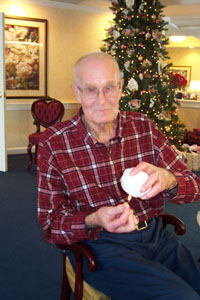 Albert Jutte, a resident of The Gardens at St. Henry, demonstrates a method he learned long ago for determining whether snow is of the wet or dry variety. Dry snow turns black as shown below when it encounters warmth from a lighted match. Wet snow quickly yields liberal drops of moisture.<br>dailystandard.com