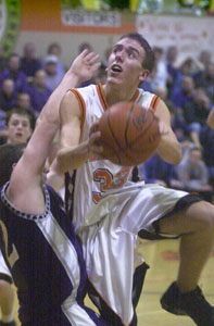 Versailles' Clint Hufford double-clutches his shot against Fort Recovery on Monday. Hufford had eight points off the bench.<br>dailystandard.com