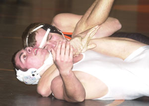 Coldwater's Brian Uhlenhake, in black, tries to pull back LCC's Alex Donely for back points during Tuesday's bout at the Pit. Uhlenhake went 2-0 during the tri-meet that also had Spencerville.<br>dailystandard.com