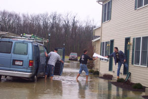 High water pants were needed when Westlake Village residents Joe Oppman Jr., Joe Oppman III and Mario Mancina, of Cleveland, moved their belongings to higher ground Thursday afternoon.<br>dailystandard.com