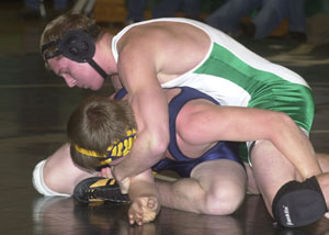 Celina's Trent Hellwarth locks up Ottawa-Glandorf's Joe Recker during Thursday's 189-pound bout. Hellwarth posted an 8-0 win to help the Bulldogs dominate the Titans, 73-4.<br>dailystandard.com