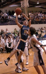 Marion Local's Wes Everman, 35, scores in between two Fort Recovery defenders during their game on Friday night. Fort Recovery defeated Marion Local, 46-42.<br>dailystandard.com