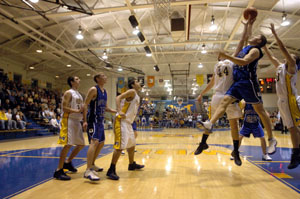 St. Marys' Adam Johns, 44, and Defiance's Graham Wagner, right, fight for a rebound during their Western Buckeye League makeup game on Tuesday evening at McBroom Gymnasium. St. Marys keeps pace on top of the WBL standing following a 46-40 victory over Defiance.<br>dailystandard.com