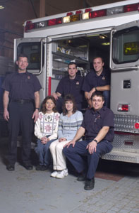 Belinda Perin, second from right, is shown with the people who came to her aid during a Nov. 19 cardiac arrest. Seated are co-worker Peggy Wyerick who initiated CPR and Celina paramedic Doug Wolters. In the second row, from left, are fellow paramedics Mike Bruns, Chris Cline and Steve Hemmelgarn who were able to restart Perin's heart. The ambulance -- Squad 9 -- is the one used that day. <br><br>dailystandard.com