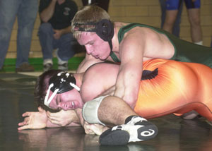 Celina's Trent Hellwarth keeps Versailles' Alex Davis on the mat during an early-round match at the Lions Invitational. Hellwarth won the 189-pound title and the Most Outstanding Wrestler award.<br>dailystandard.com