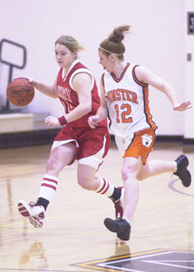St. Henry's Brenda Hemmelgarn, left, tries to bring the ball up the court against the defensive pressure of Minster's Danae Spieles. Minster defeated St. Henry, 79-51.<br>dailystandard.com