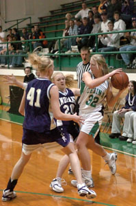 Fort Recovery's Tiffany Gaerke, 41, and teammate Sara Fort-kamp, 20, trap Celina's Laura Link, 32, during their contest on Tuesday night. Link scored a game-high 20 points but it wasn't enough as the Indians defeated the Bulldogs, 54-46.<br>dailystandard.com