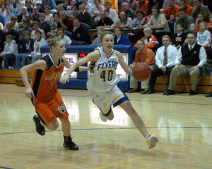 Marion Local's Katelyn Mescher, 40, drives past Minster's Karen Brackman during Thursday's MAC game at the Hangar.<br>dailystandard.com