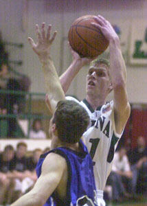 Celina's Eric Klosterman, with ball, shoots over a Defiance defender during their Western Buckeye League game on Friday night at the Fieldhouse. Klosterman was perfect from the floor and the free-throw line scoring 14 points and helping Celina to a 72-42 win over Defiance.<br>dailystandard.com