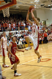 Kurt Huelsman, 41, reacts as teammate Nate Stahl goes up for the dunk during Saturday's matchup with Van Wert.<br>dailystandard.com