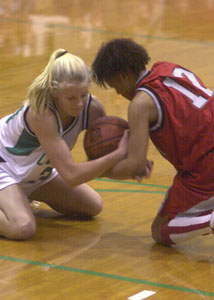 Celina's Julie Snyder, left, fights for the ball with Lima Senior's Shannon Williamson, right, during their game on Tuesday night at the Fieldhouse. Celina won the game, 57-42.<br>dailystandard.com