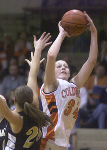 Coldwater's Kendra Robbins, right, shoots over Botkins' Alisha Grieves, left, during their game at The Palace on Tuesday. Coldwater defeated Botkins, 53-39.<br>dailystandard.com