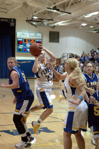 Marion Local's Kelli Stucke, with ball, shoots in the lane between two St. Marys defenders during their game on Tuesday night. Stucke had 10 points to help Marion Local to a 42-37 win.<br>dailystandard.com
